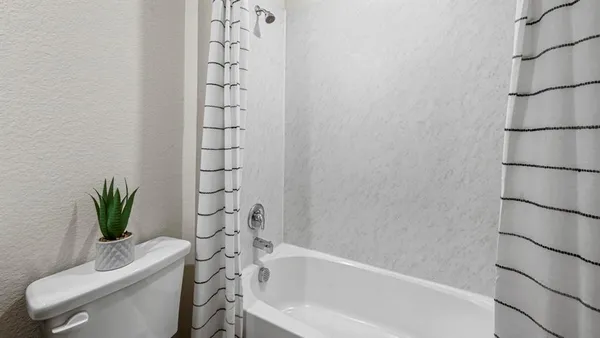 a bathroom with a toilet and a bathtub