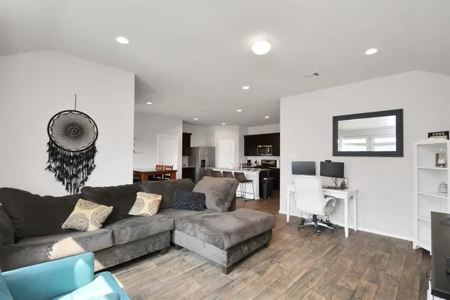 a living room with furniture and a mirror