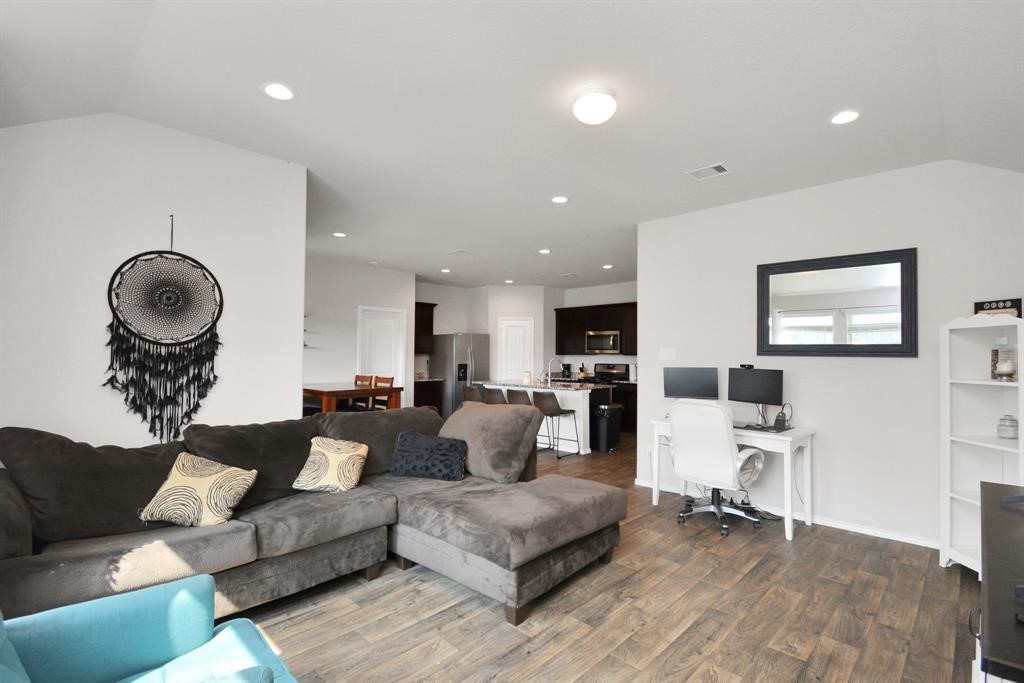 1602 Brownwood Ridge Court Richmond, TX 77469 - Photo 13 of 35 a living room with furniture and a mirror