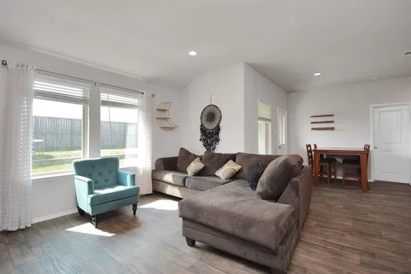 a living room with furniture and a large window