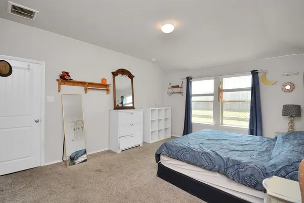 a bedroom with a bed and a dresser