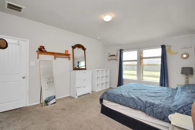 a bedroom with a bed and a dresser