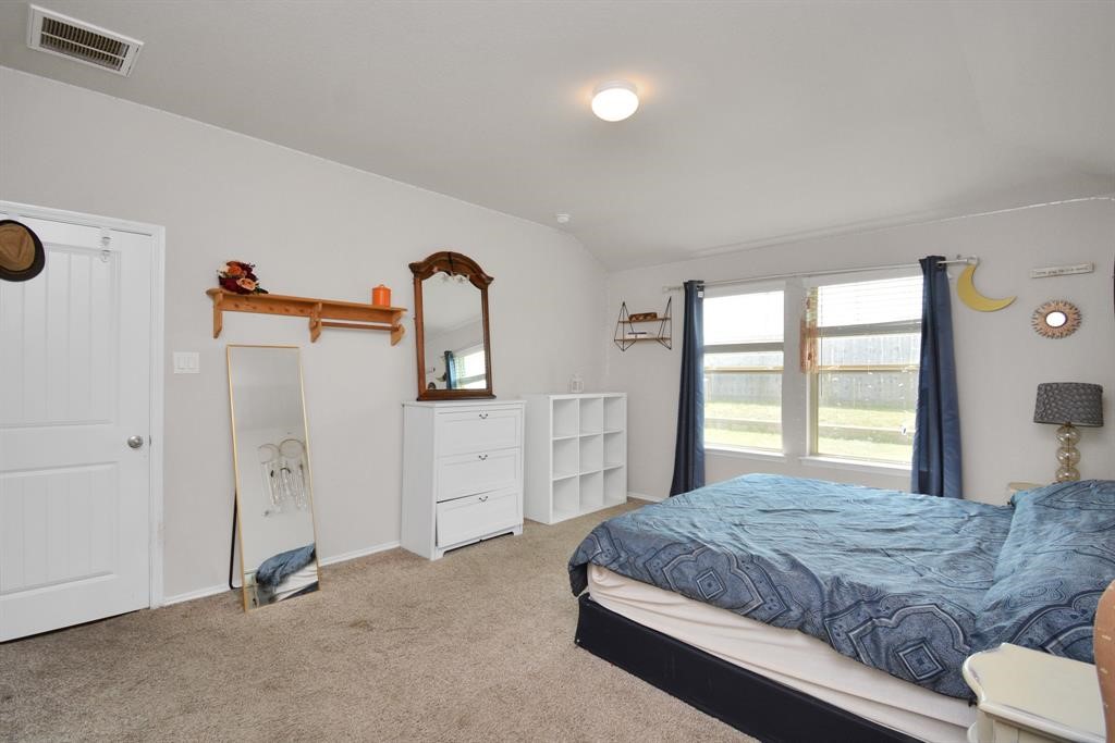 1602 Brownwood Ridge Court Richmond, TX 77469 - Photo 15 of 35 a bedroom with a bed and a dresser