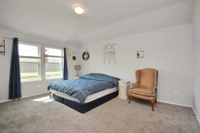 a living room with a bed furniture and a window