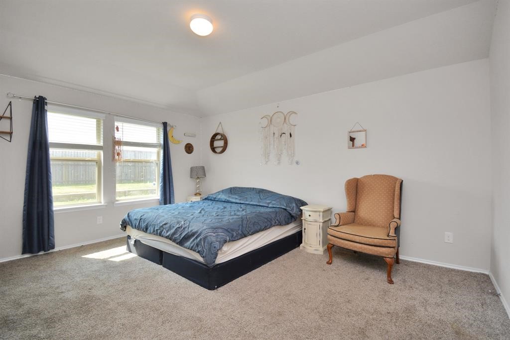 1602 Brownwood Ridge Court Richmond, TX 77469 - Photo 16 of 35 a living room with a bed furniture and a window