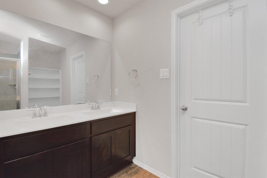 1602 Brownwood Ridge Court Richmond, TX 77469 - Photo 18 of 35 a bathroom with a sink and a mirror