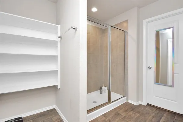 a view of walk in closet with empty racks