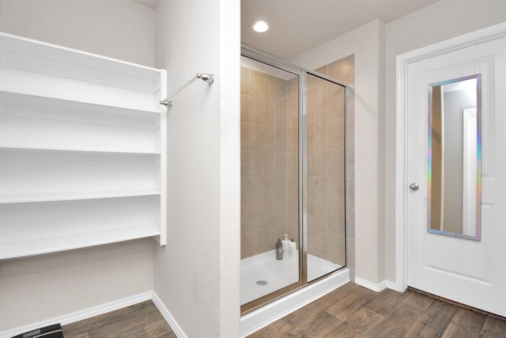 1602 Brownwood Ridge Court Richmond, TX 77469 - Photo 19 of 35 a view of walk in closet with empty racks