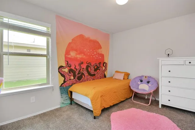 a bedroom with a bed and a window