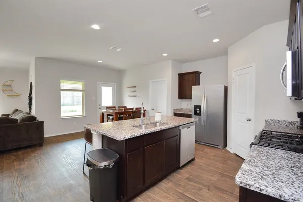 a kitchen with a stove and a refrigerator