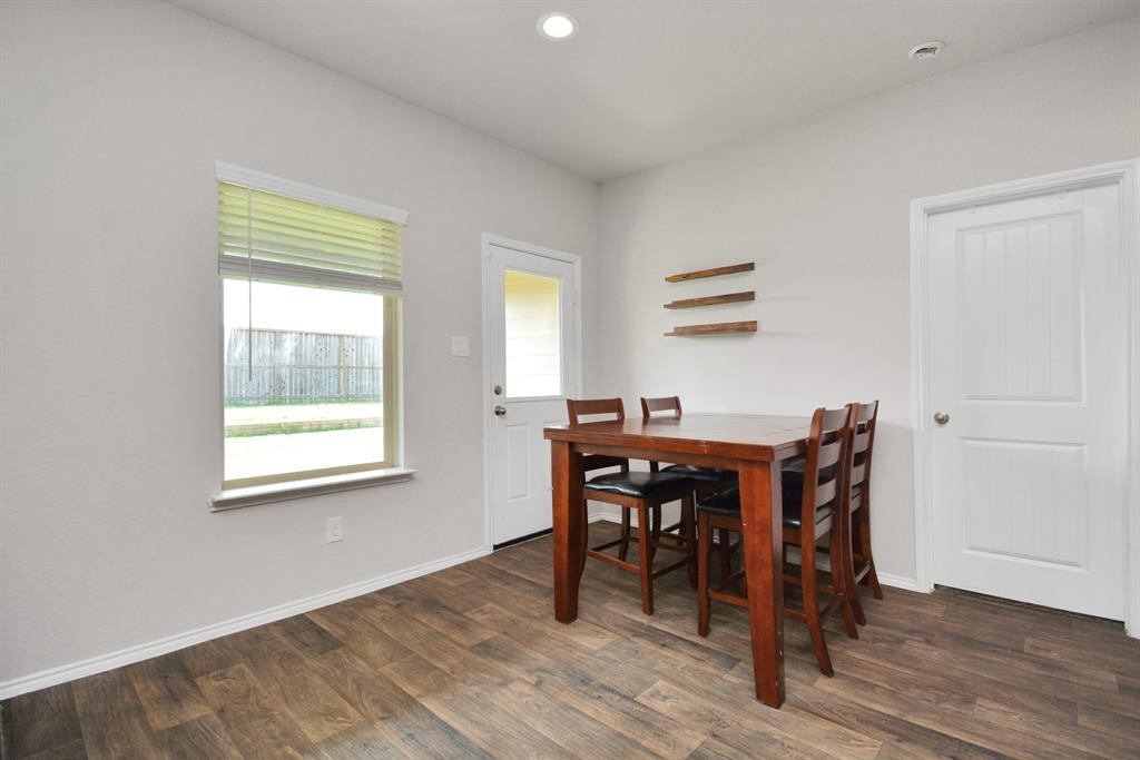 1602 Brownwood Ridge Court Richmond, TX 77469 - Photo 9 of 35 a view of a dining room with furniture and wooden floor