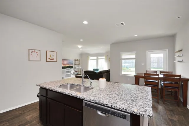 a kitchen with counter space and dining table