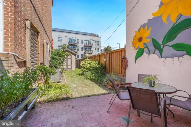 a view of a chairs and table in a backyard