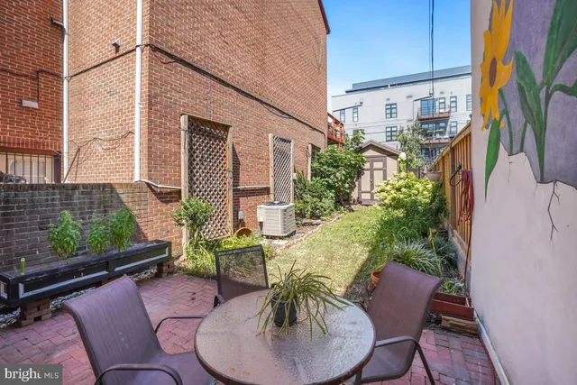 a backyard of a house with outdoor seating