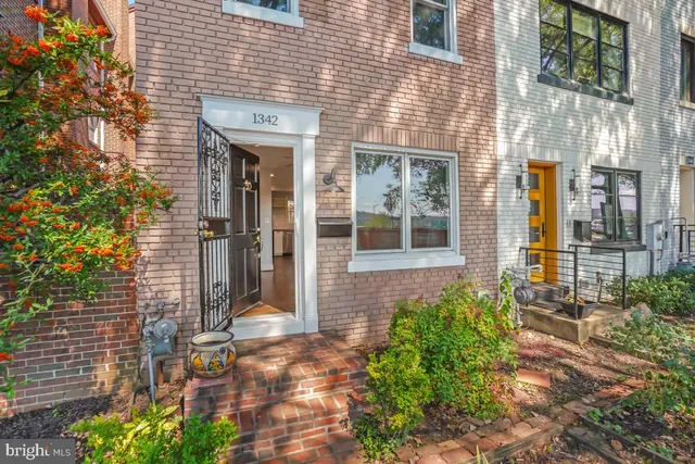 a front view of a brick house with a large window