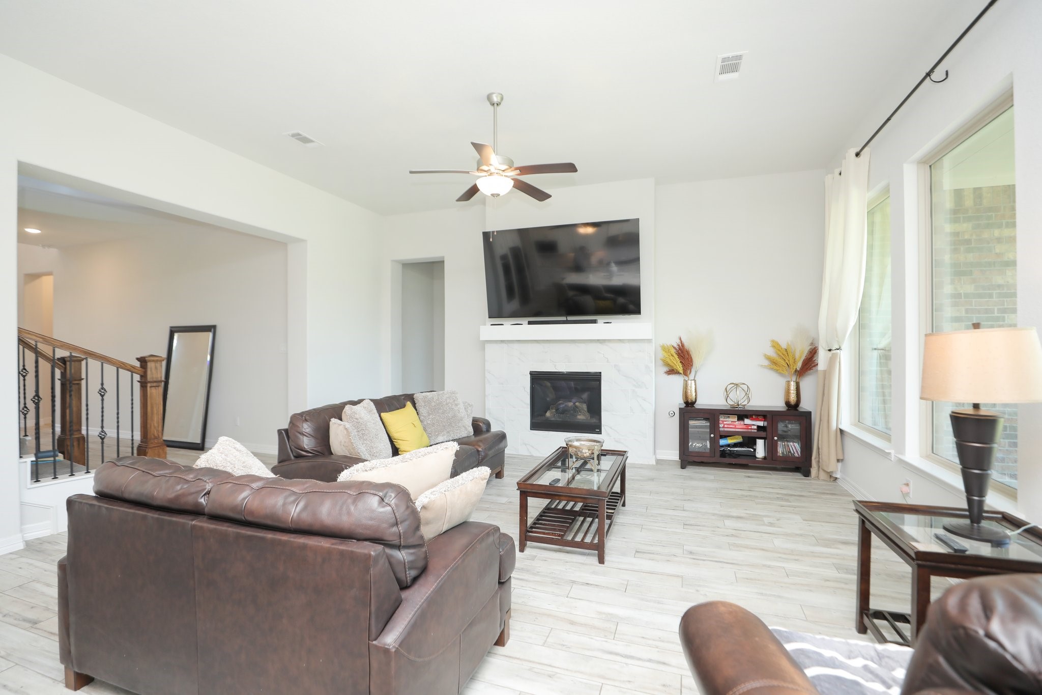 10134 Blythe Street Rosharon, TX 77583 - Photo 14 of 50 a living room with furniture a fireplace and a flat screen tv