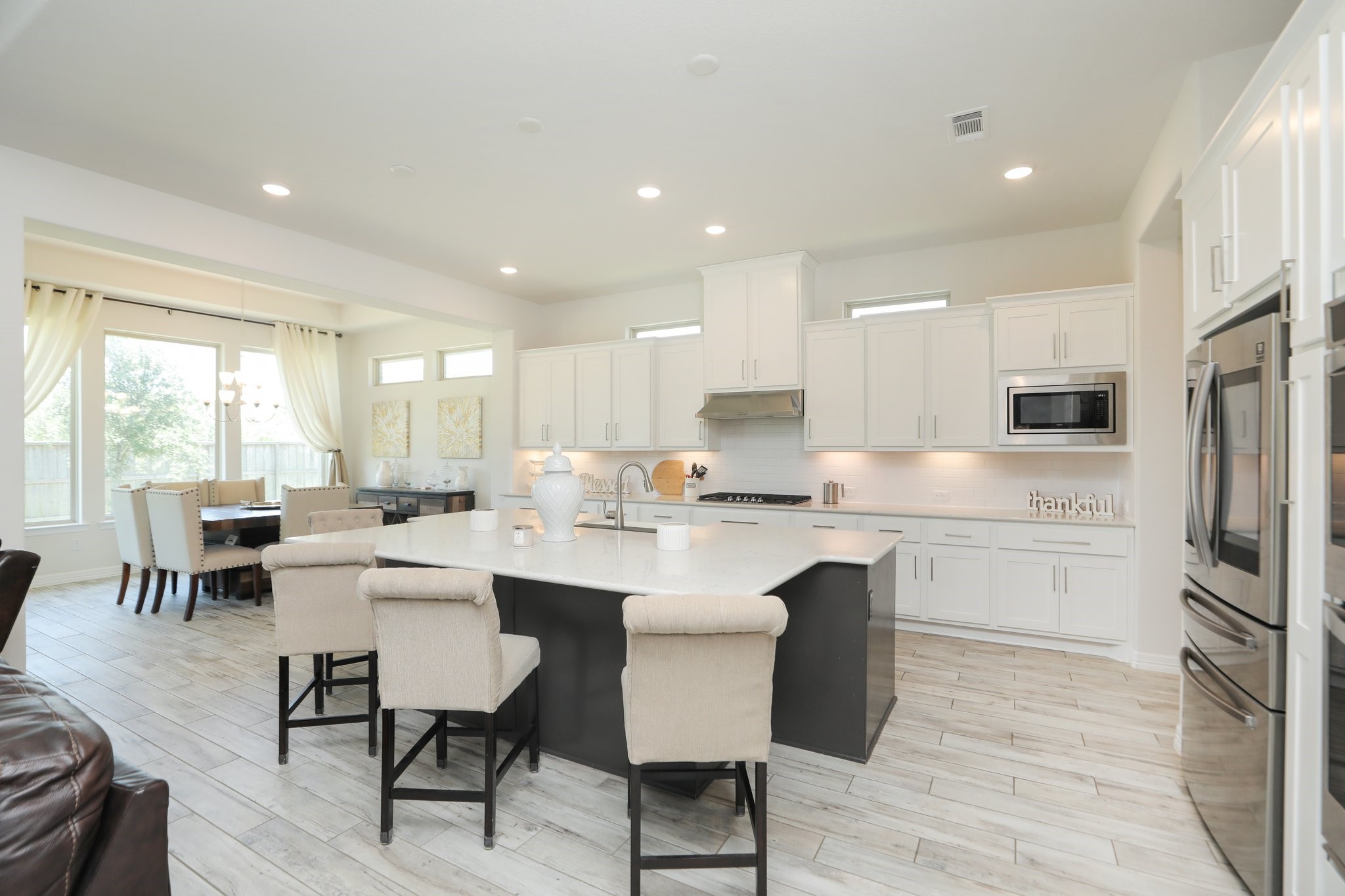 10134 Blythe Street Rosharon, TX 77583 - Photo 20 of 50 a kitchen with a sink white cabinets and refrigerator