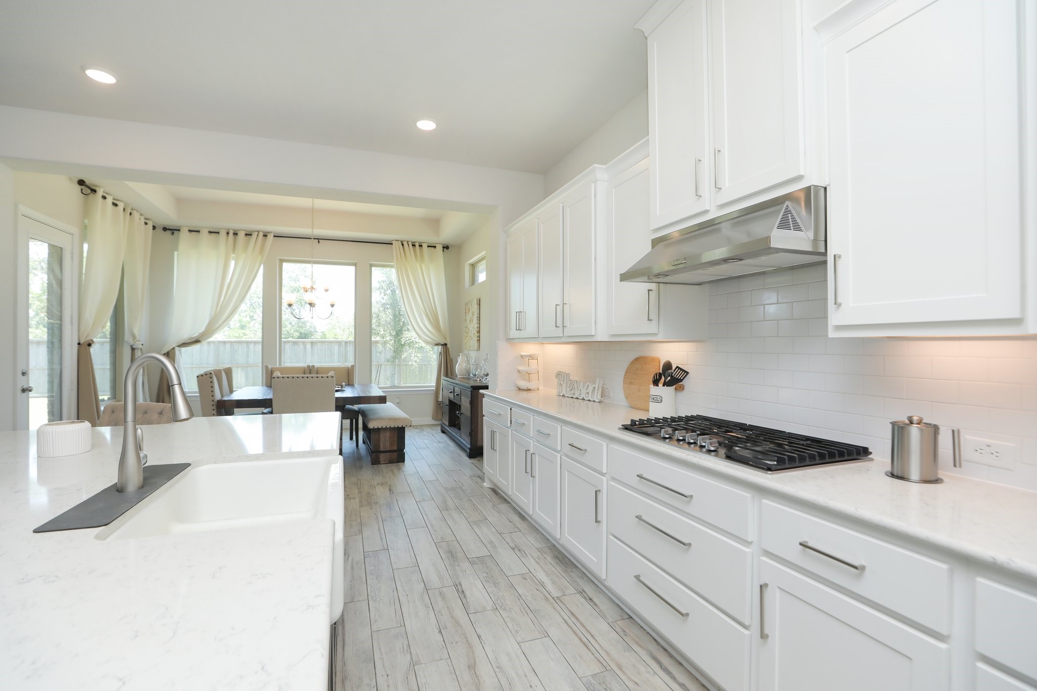 10134 Blythe Street Rosharon, TX 77583 - Photo 23 of 50 a kitchen with stainless steel appliances kitchen island granite countertop a lot of counter space and wooden floors