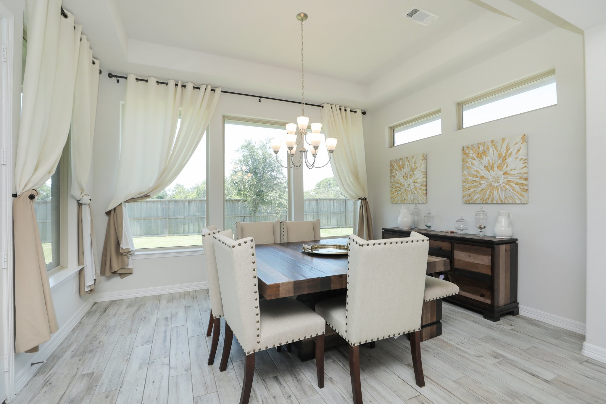 10134 Blythe Street Rosharon, TX 77583 - Photo 26 of 50 a dining room with furniture a chandelier and wooden floor