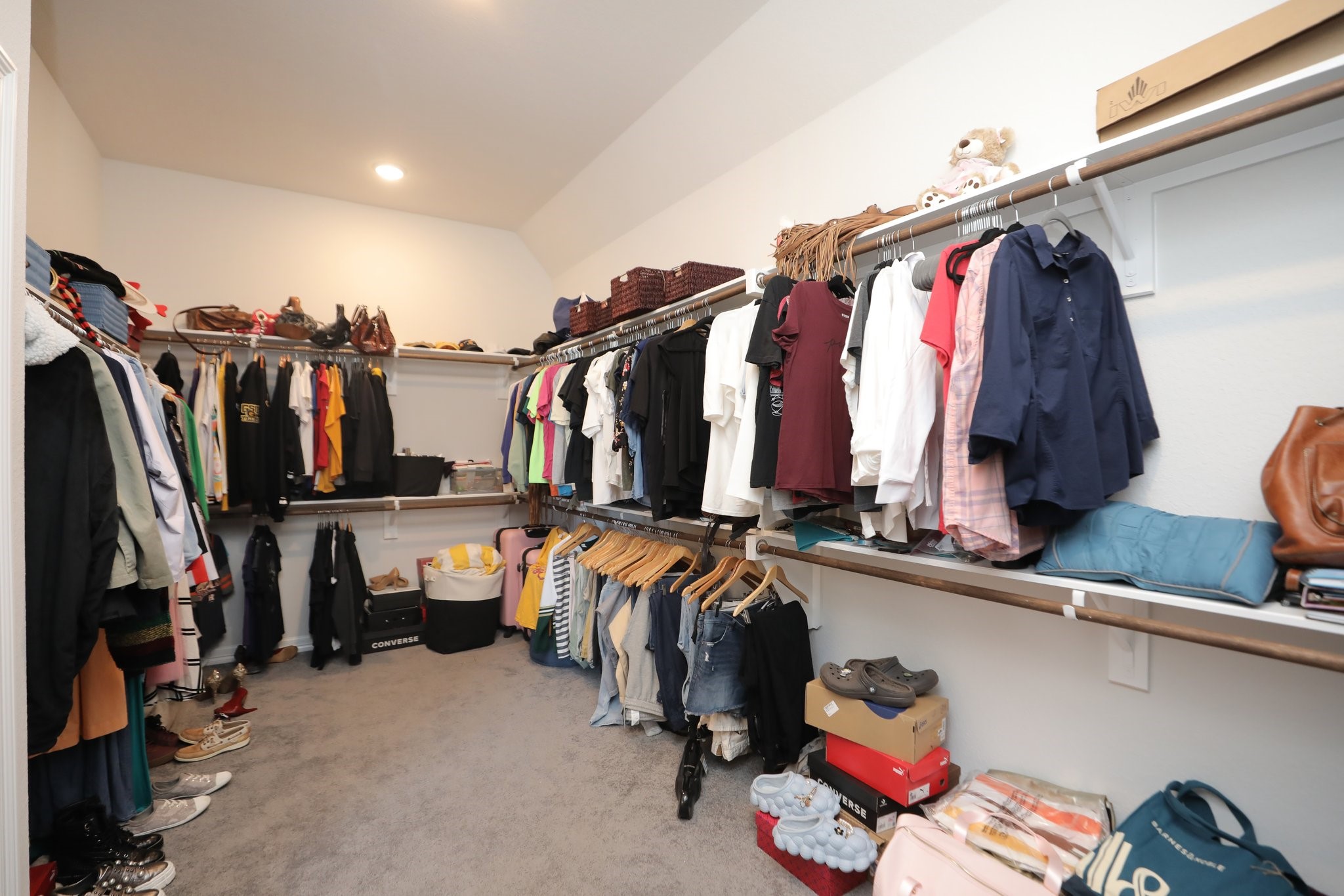 10134 Blythe Street Rosharon, TX 77583 - Photo 34 of 50 a view of walk in closet with clothes and shoes
