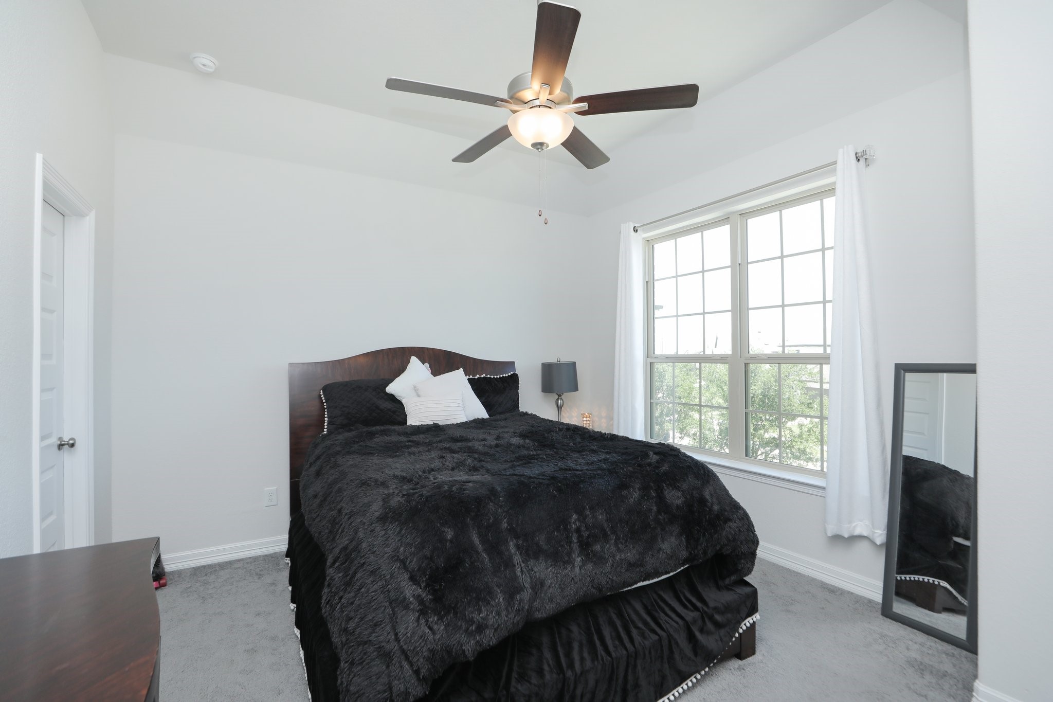 10134 Blythe Street Rosharon, TX 77583 - Photo 35 of 50 a bedroom with a bed and a flat tv screen on dresser