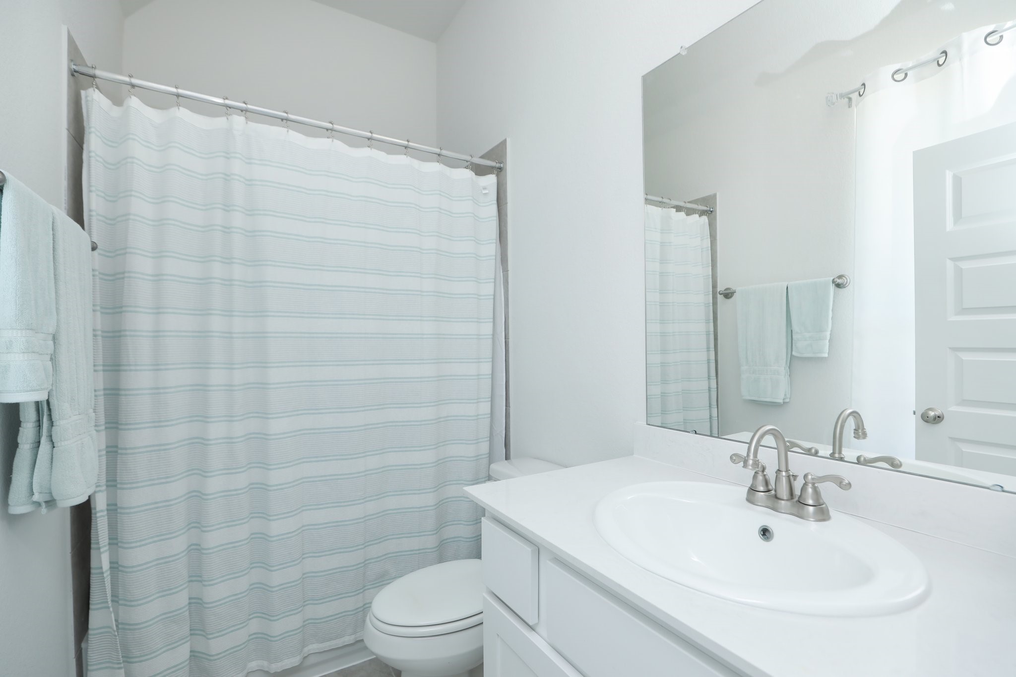 10134 Blythe Street Rosharon, TX 77583 - Photo 36 of 50 a bathroom with a sink a toilet and shower curtain