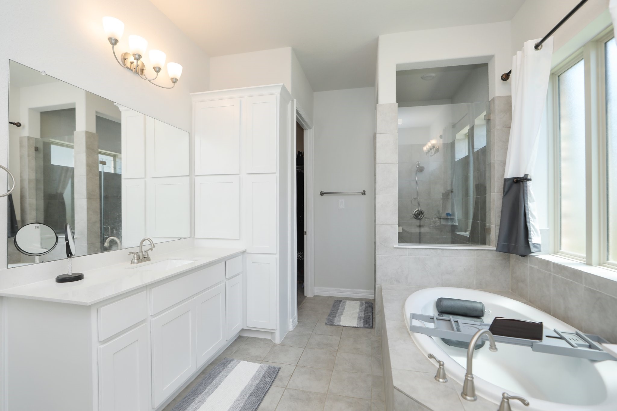 10134 Blythe Street Rosharon, TX 77583 - Photo 43 of 50 a bathroom with a double vanity sink and a mirror