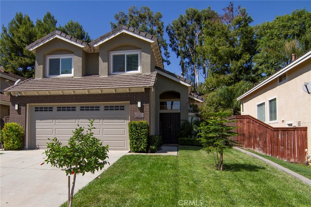 17677 Morning Sun Court Riverside, CA 92503 - Photo 1 of 1 a front view of a house with a garden and plants