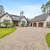 a front view of a house with a garden and plants