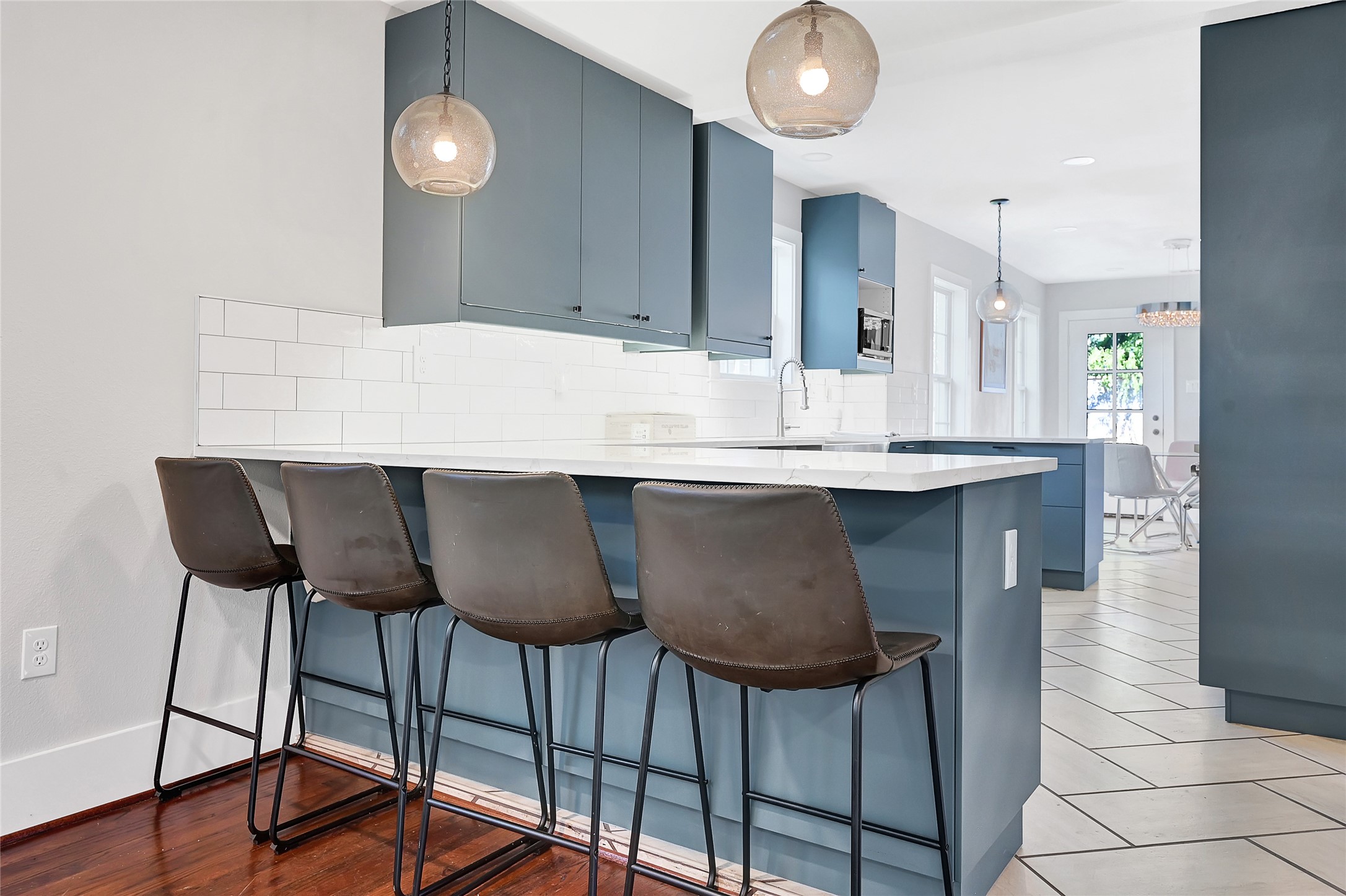 3343 Tampa Street Houston, TX 77021 - Photo 9 of 41 a kitchen with stainless steel appliances kitchen island a table chairs in it and wooden floor