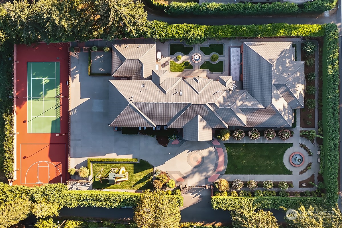 an aerial view of a house with a yard swimming pool and outdoor seating