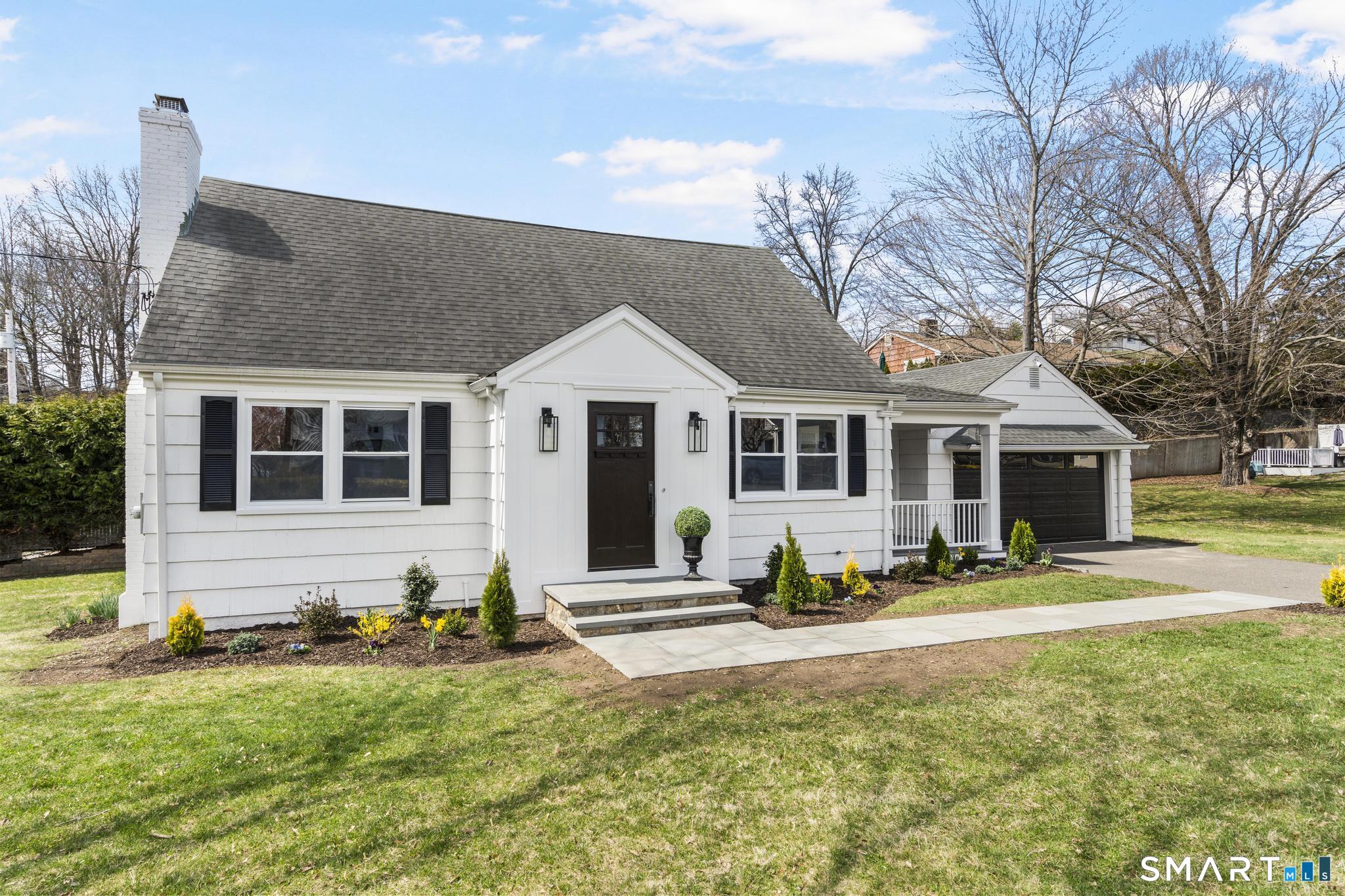 a view of a house with backyard and sitting area
