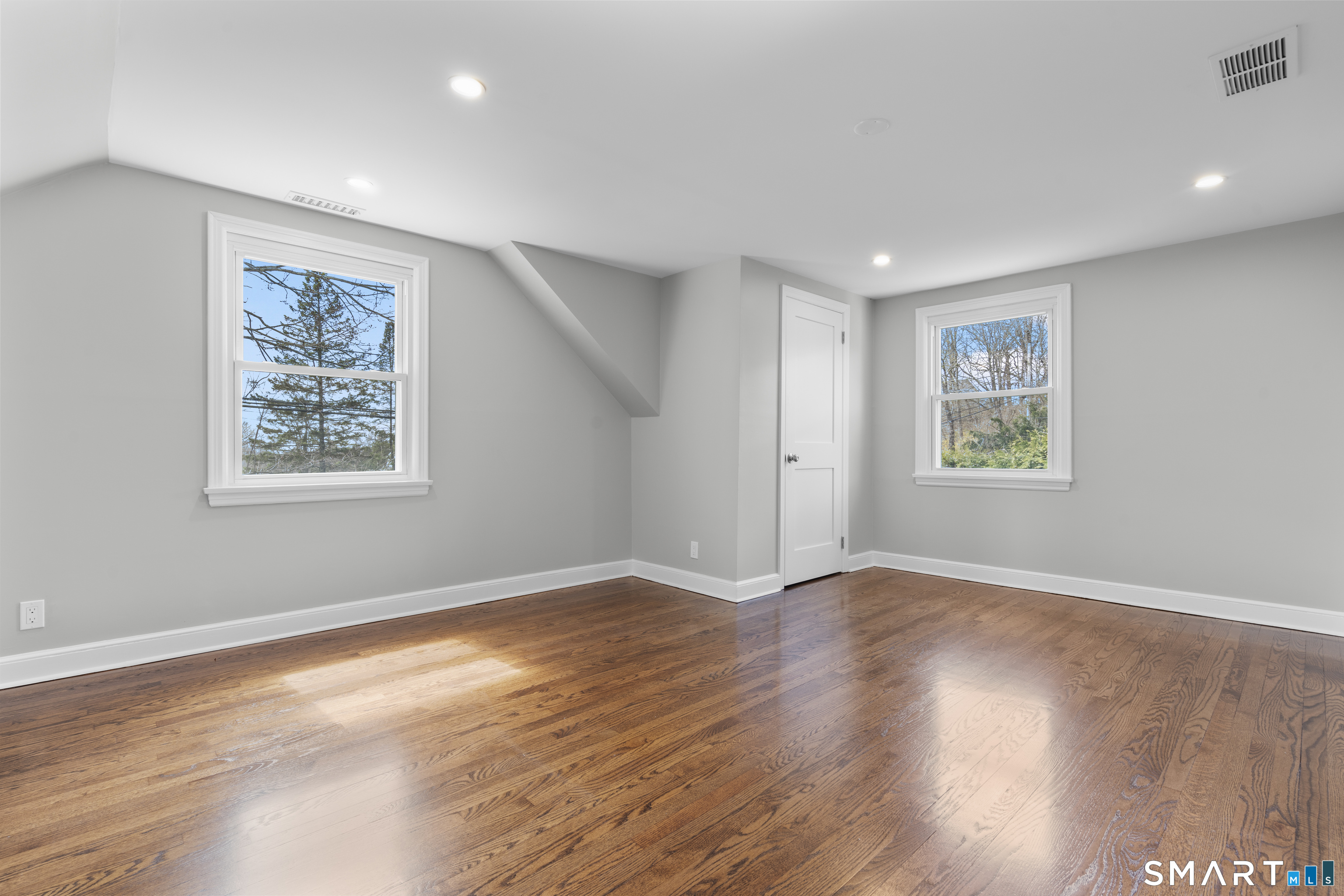 7 Fairview Avenue Trumbull, CT 06611 - Photo 13 of 19 a view of an empty room with window and wooden floor