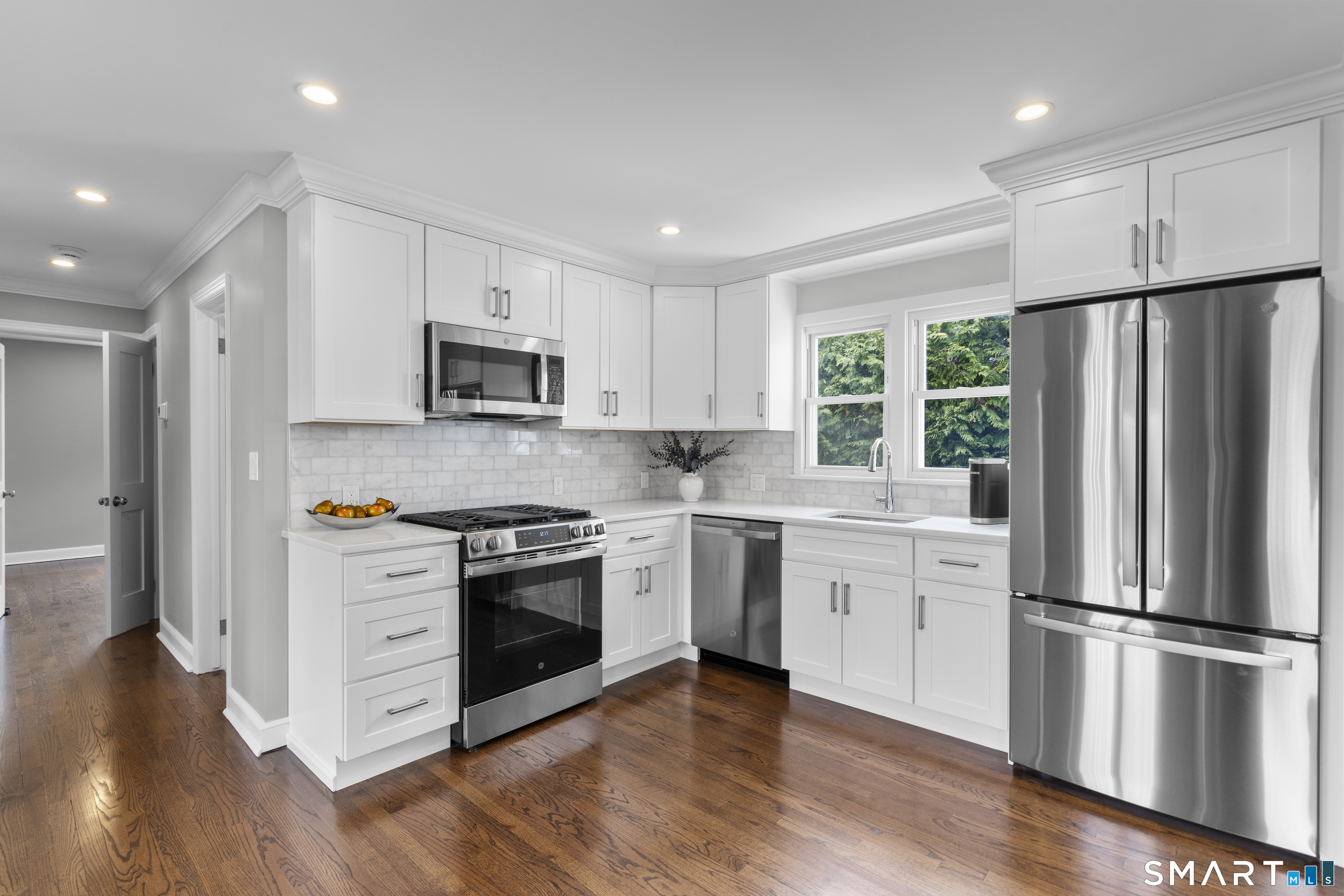 7 Fairview Avenue Trumbull, CT 06611 - Photo 3 of 19 a kitchen with granite countertop white cabinets and stainless steel appliances