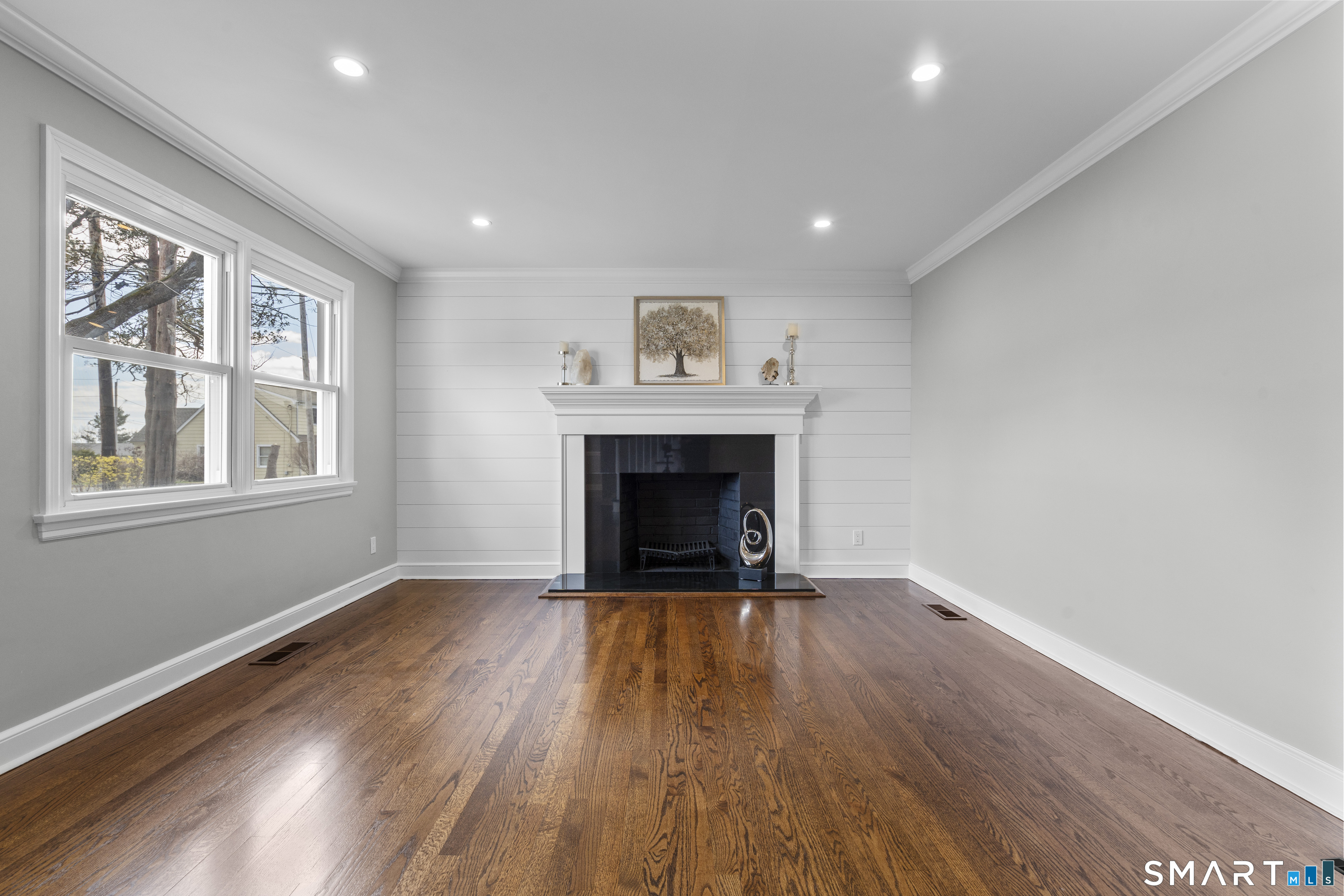 7 Fairview Avenue Trumbull, CT 06611 - Photo 8 of 19 a view of an empty room with wooden floor fireplace and a window
