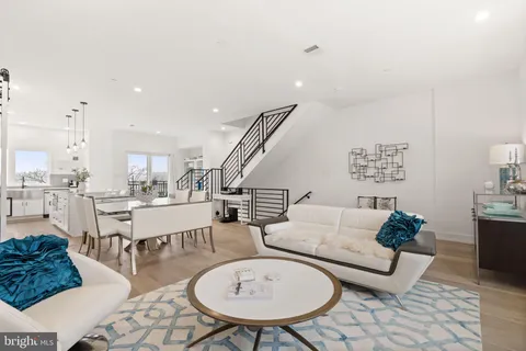 a dining room with furniture and wooden floor