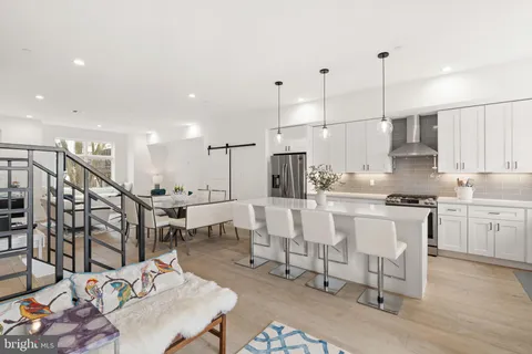 a kitchen with stainless steel appliances granite countertop a sink stove and cabinets