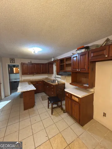a kitchen with stainless steel appliances granite countertop a sink stove and granite counter top