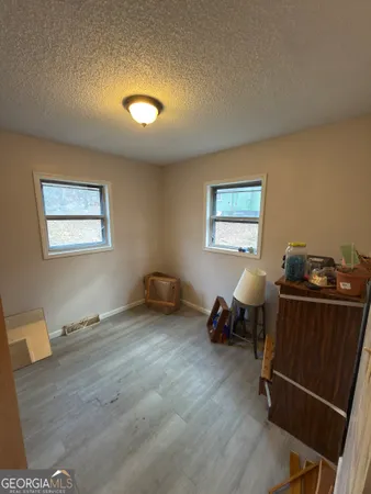 a bathroom with a granite countertop sink a toilet and shower