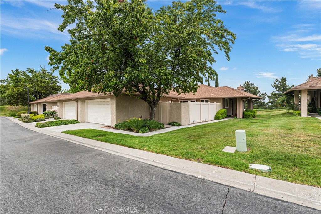 a front view of a house with a yard and a garage