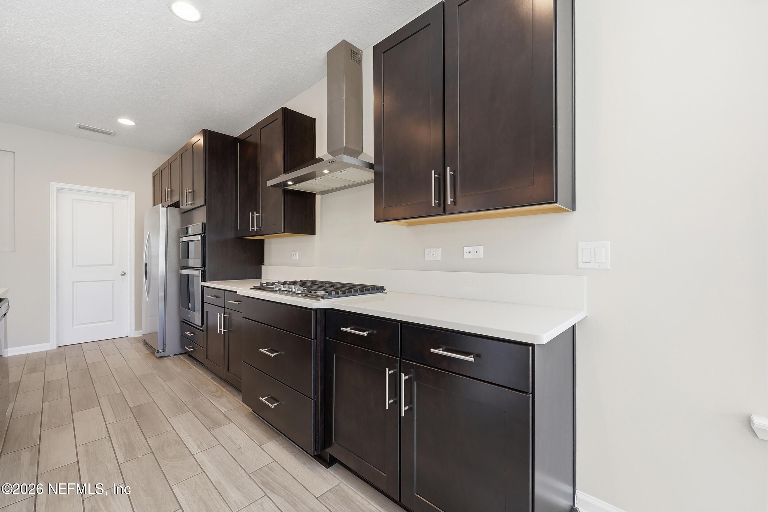 95 Strobe Court St. Augustine, FL 32095 - Photo 16 of 71 a kitchen with stainless steel appliances granite countertop a sink stove and refrigerator