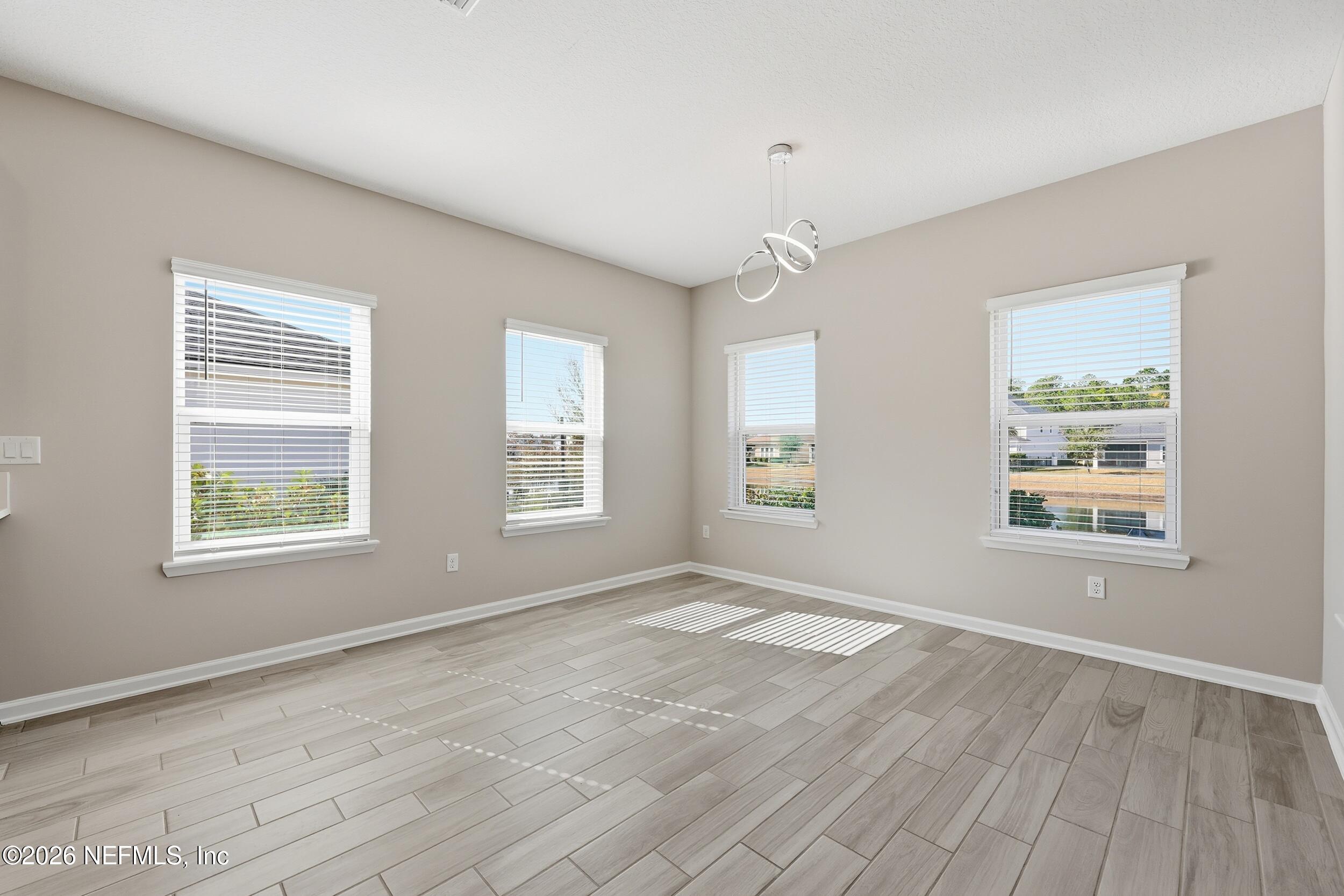 95 Strobe Court St. Augustine, FL 32095 - Photo 17 of 71 an empty room with wooden floor and windows