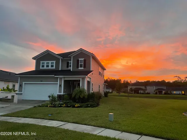 a dining room with lots of wooden furniture and a chandelier