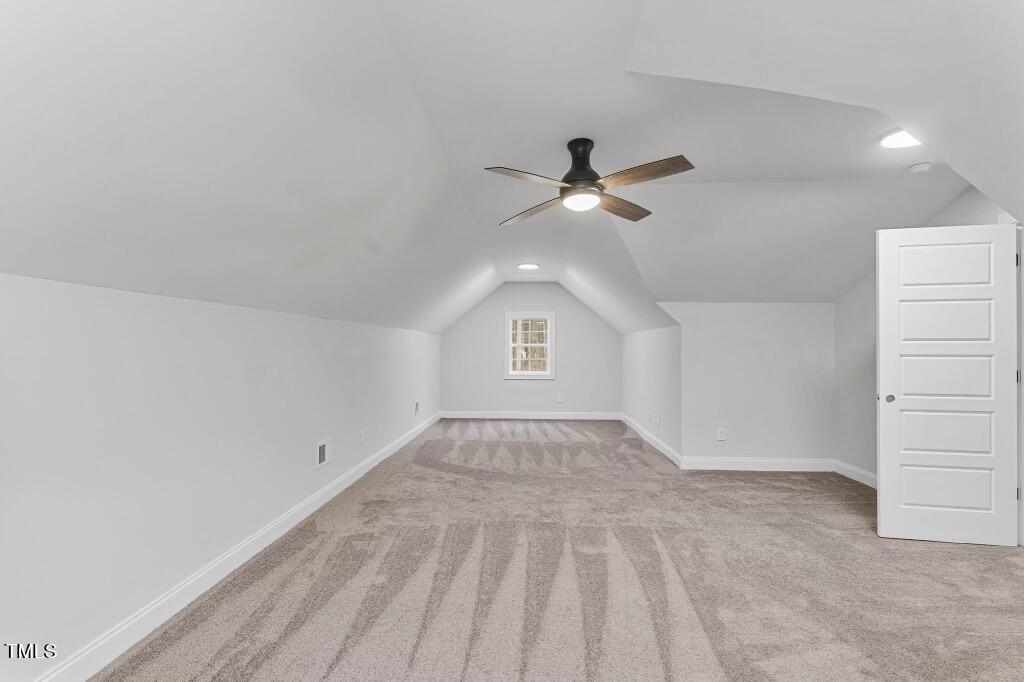 a view of an empty room with a ceiling fan