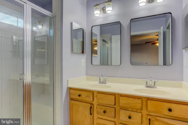 a bathroom with a double vanity sink and mirror