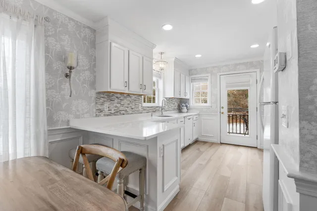 a kitchen with a refrigerator and a sink