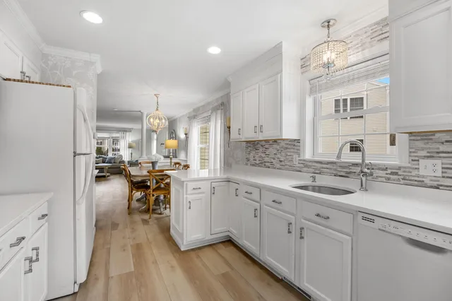 a kitchen with sink cabinets and wooden floor