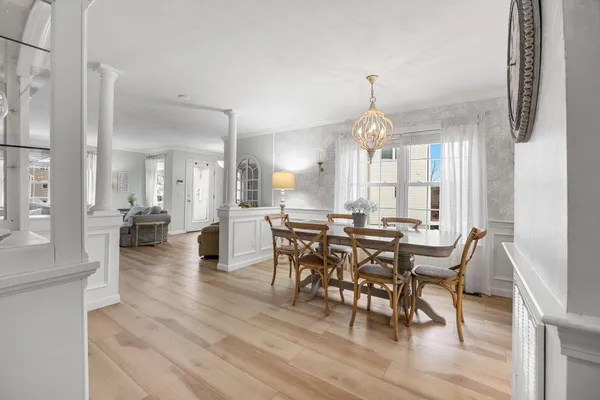 a view of a a dining room with furniture window and wooden floor