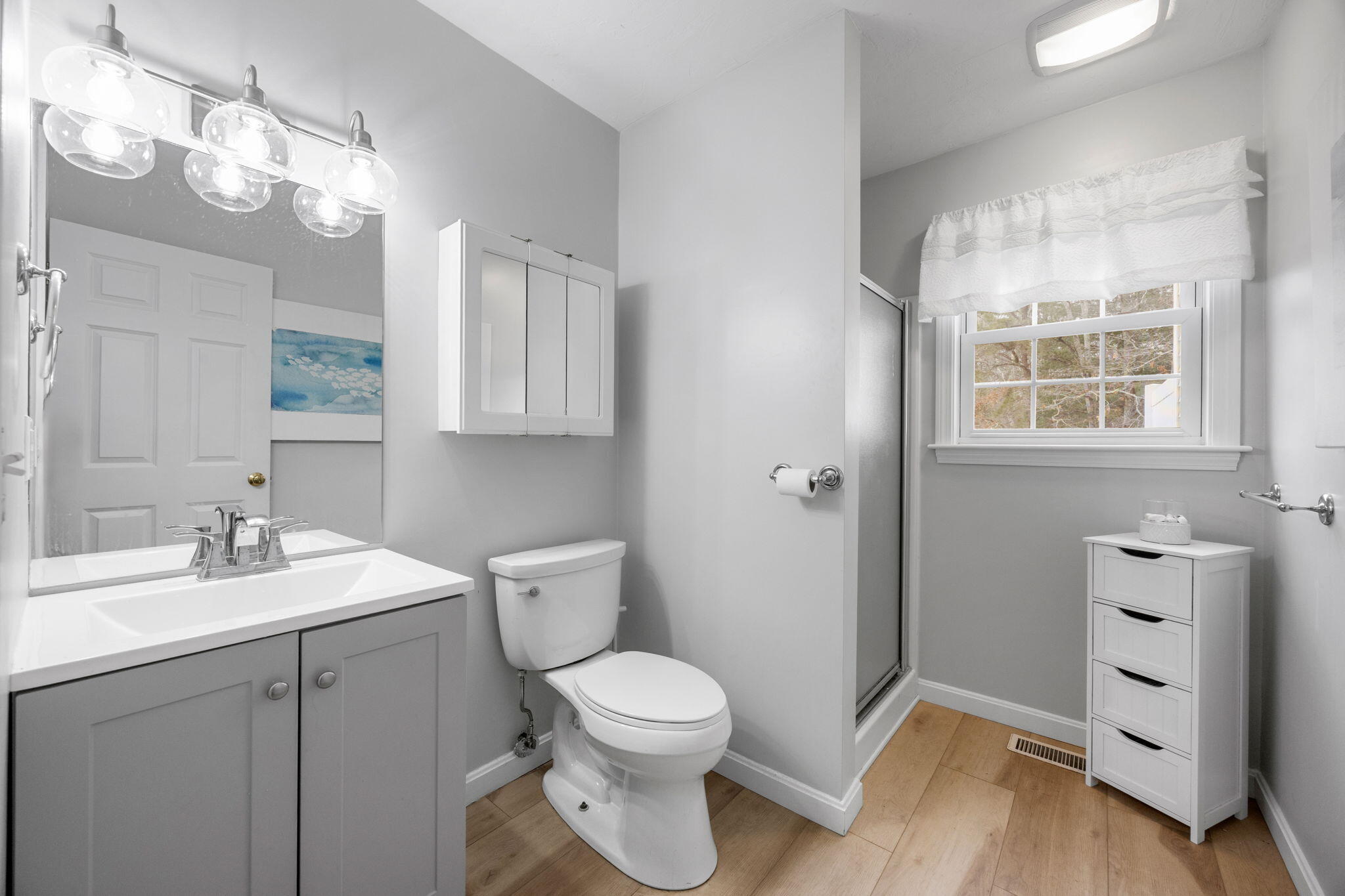 32 Carleton Street, Unit 32 Onset, MA 02558 - Photo 17 of 34 a bathroom with a toilet a sink a mirror a vanity and window