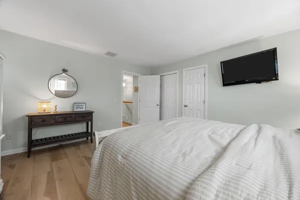 a bedroom with bed and a flat screen tv